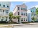 Charming three-story home with a pastel pink exterior and manicured front yard in suburban setting at 4429 Avery Ave, North Charleston, SC 29405