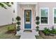 Inviting front entrance featuring a dark blue door, potted topiaries, and well-maintained landscaping at 4429 Avery Ave, North Charleston, SC 29405