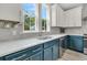 A modern kitchen featuring two-toned cabinetry, stainless steel appliances, and bright natural light at 4429 Avery Ave, North Charleston, SC 29405