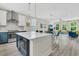 Open-concept kitchen featuring a large island, modern appliances, and seamless flow into the living area at 4429 Avery Ave, North Charleston, SC 29405