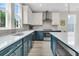 Modern kitchen boasts two-toned cabinets, stainless steel appliances, and island with countertop seating at 4429 Avery Ave, North Charleston, SC 29405