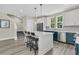 Open-concept kitchen features an island, two-toned cabinets, stainless appliances, and barstool seating at 4429 Avery Ave, North Charleston, SC 29405