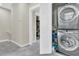 Convenient laundry space features stacked washer and dryer units, with view of the open closet in background at 4429 Avery Ave, North Charleston, SC 29405