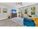 Stylish living room featuring modern furniture, a media cabinet, and abundant natural light from large windows at 4429 Avery Ave, North Charleston, SC 29405