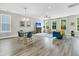 Stylish living room featuring modern furniture, large windows, and beautiful hardwood flooring at 4429 Avery Ave, North Charleston, SC 29405