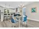 Inviting living room with modern furniture, glass dining table and kitchen in the background at 4429 Avery Ave, North Charleston, SC 29405