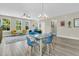 Open-concept living room featuring modern furniture, large windows, and light hardwood flooring at 4429 Avery Ave, North Charleston, SC 29405