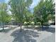 Outdoor dining area with umbrella-shaded tables, picnic benches, and ample green space for a relaxed atmosphere at 4429 Avery Ave, North Charleston, SC 29405