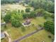 Expansive property with a cozy home, lush greenery, and a serene pond in a tranquil neighborhood at 449 Mary Lou Ln, Moncks Corner, SC 29461