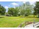 Expansive backyard with lush green grass, mature trees, and a wooden deck with flower boxes at 449 Mary Lou Ln, Moncks Corner, SC 29461