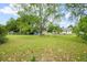 Large backyard featuring mature trees, grass coverage, and a view of the house at 449 Mary Lou Ln, Moncks Corner, SC 29461