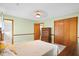Bedroom featuring light green walls, carpet flooring, closet, wooden furniture, and access to the bathroom at 449 Mary Lou Ln, Moncks Corner, SC 29461