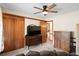 Spacious bedroom with a large closet, wooden furniture, ceiling fan, and access to another room at 449 Mary Lou Ln, Moncks Corner, SC 29461