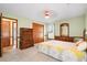 Well-lit bedroom with light green walls, closet, ceiling fan, and traditional-style wooden furniture set at 449 Mary Lou Ln, Moncks Corner, SC 29461