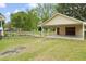 A detached two car garage featuring an open carport and a door for secured parking and storage at 449 Mary Lou Ln, Moncks Corner, SC 29461