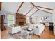 Inviting living room boasts vaulted ceilings, a brick fireplace, hardwood floors and ample natural light at 449 Mary Lou Ln, Moncks Corner, SC 29461