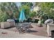 Outdoor grilling area perfect for summer BBQs complete with a large umbrella, chairs, and tables at 45 Sycamore Ave # 1532, Charleston, SC 29407