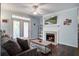 Inviting living room featuring a cozy fireplace, ceiling fan, and access to the outdoor balcony at 45 Sycamore Ave # 1532, Charleston, SC 29407