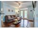 Inviting living room with a comfortable sofa, ceiling fan, fireplace, and access to a balcony at 45 Sycamore Ave # 1532, Charleston, SC 29407