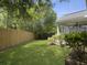 Manicured backyard with lush green grass, a wood privacy fence, and landscaping at 462 Maple Oak Ln, Charleston, SC 29414