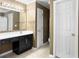 Spacious bathroom with a black vanity, and large mirror at 462 Maple Oak Ln, Charleston, SC 29414