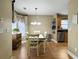 Bright dining area with a bay window and chandelier lighting next to the kitchen at 462 Maple Oak Ln, Charleston, SC 29414