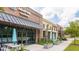 Commercial building exterior with outdoor seating, a gray awning, and manicured landscaping at 462 Maple Oak Ln, Charleston, SC 29414