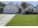 Charming single-story home with a manicured lawn, two-car garage, and inviting curb appeal at 462 Maple Oak Ln, Charleston, SC 29414