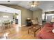 Open-concept living room with hardwood floors connecting to the dining area and kitchen at 462 Maple Oak Ln, Charleston, SC 29414
