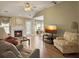 Comfortable living room with hardwood floors, a fireplace, and a view of the eat-in kitchen at 462 Maple Oak Ln, Charleston, SC 29414