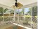 Relaxing screened porch with latticework and ceiling fan offers a serene outdoor living space at 462 Maple Oak Ln, Charleston, SC 29414