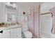Well-lit bathroom features elegant fixtures, a decorative mirror, and a shower with stylish curtain at 509 Gilberts Lndg, Mount Pleasant, SC 29464