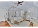 Light-filled bedroom with a canopy bed, hardwood floors, a ceiling fan and plantation shutters at 509 Gilberts Lndg, Mount Pleasant, SC 29464
