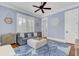 Serene bedroom with blue walls, plantation shutters, and decorative ceiling fan at 509 Gilberts Lndg, Mount Pleasant, SC 29464