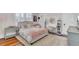 Light bedroom featuring a bed with pink accents, a shag rug, shutters, and a writing desk at 509 Gilberts Lndg, Mount Pleasant, SC 29464