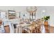Open-concept dining area with stylish chandelier and seating for eight, connecting to living room and kitchen at 509 Gilberts Lndg, Mount Pleasant, SC 29464