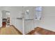 Bright hallway features wood floors, white railings, modern lighting and access to a bedroom with light pink accents at 509 Gilberts Lndg, Mount Pleasant, SC 29464