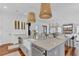 Bright kitchen features marble countertops, farmhouse sink, custom cabinets, and stylish lighting fixtures at 509 Gilberts Lndg, Mount Pleasant, SC 29464
