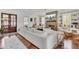 Inviting living room featuring a brick fireplace, built-in shelves, hardwood floors, and comfortable white seating at 509 Gilberts Lndg, Mount Pleasant, SC 29464