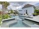 Beautiful swimming pool with a hot tub, surrounded by tropical landscaping and stylish outdoor furniture at 509 Gilberts Lndg, Mount Pleasant, SC 29464