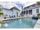 Backyard pool featuring lounge chairs, a spa, and a screened porch, perfect for outdoor relaxation and entertaining at 509 Gilberts Lndg, Mount Pleasant, SC 29464