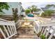 Inviting back porch with wooden chairs overlooking the charming backyard and neighborhood at 5153 Celtic Dr, North Charleston, SC 29405