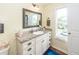 Charming bathroom with a vanity, granite countertop, drawers, and a framed mirror at 5153 Celtic Dr, North Charleston, SC 29405