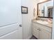 Bathroom featuring granite countertop vanity with white cabinets and framed mirror above the sink at 5153 Celtic Dr, North Charleston, SC 29405
