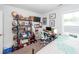Cozy bedroom featuring a computer desk, shelving, and a large window for ample natural light at 5153 Celtic Dr, North Charleston, SC 29405