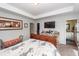 Comfortable bedroom with a media center, and a view into an en suite bathroom and walk-in closet at 5153 Celtic Dr, North Charleston, SC 29405