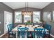 Formal dining room with seating for six, featuring a modern chandelier, and light reflecting from the outside windows at 5153 Celtic Dr, North Charleston, SC 29405