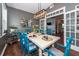 Formal dining room with seating for six, featuring a modern chandelier, and light reflecting from the outside windows at 5153 Celtic Dr, North Charleston, SC 29405