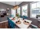 Dining room with seating for six, featuring a modern chandelier, and light reflecting from the outside windows at 5153 Celtic Dr, North Charleston, SC 29405
