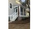 Home exterior featuring an enclosed porch with stairs and a newly laid lawn at 5153 Celtic Dr, North Charleston, SC 29405